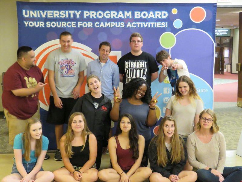 The leadership team posing in front of sign saying - University Program Board: Your source for Campus Activities.