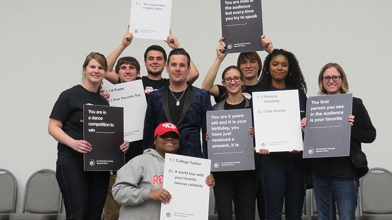 Group of students holding signs during a UPB event.